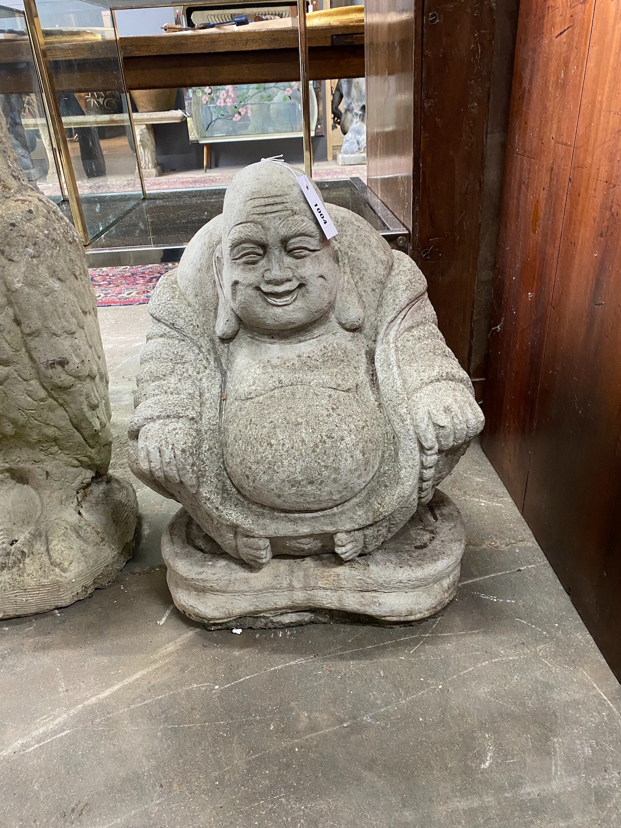 A reconstituted stone seated buddha garden ornament, height 50cm
